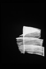 An abstract painting featuring bold black strokes.