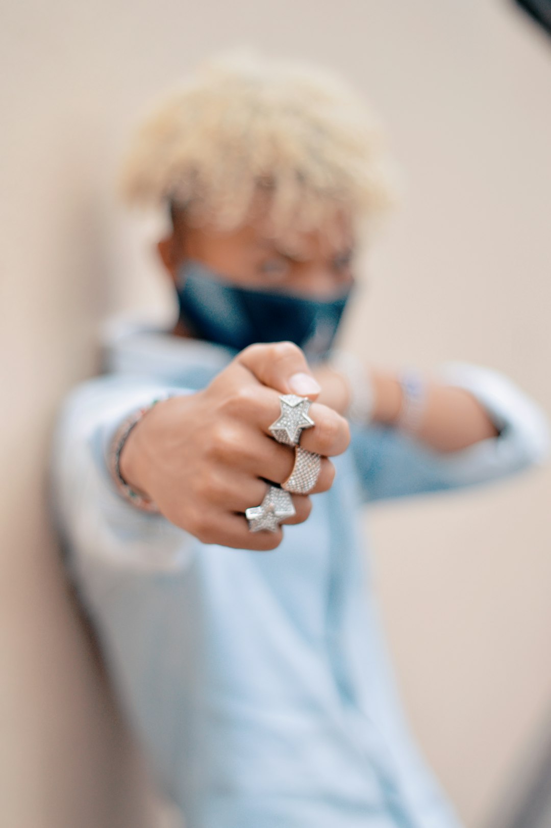 woman in white long sleeve shirt wearing silver ring