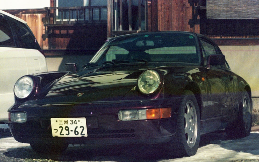 black porsche 911 parked near building