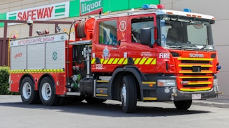 Fire truck parked in front of a municipal fire station in Argentina.