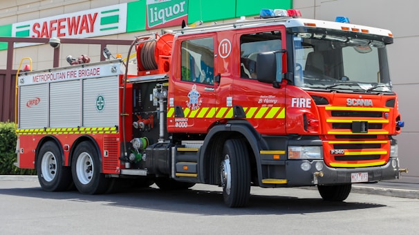 Fire truck parked in front of a municipal fire station in Argentina.
