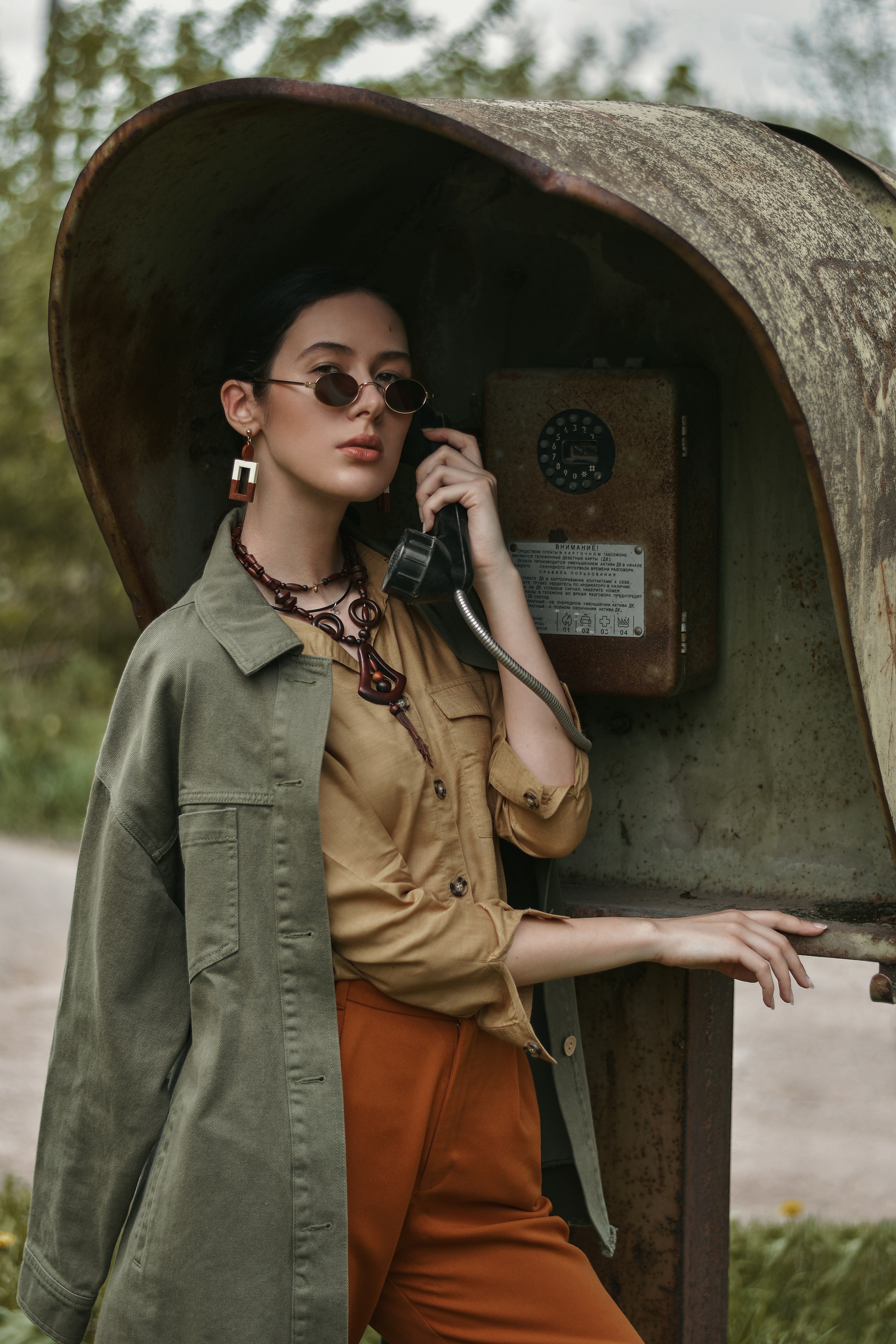 woman in brown coat wearing black sunglasses
