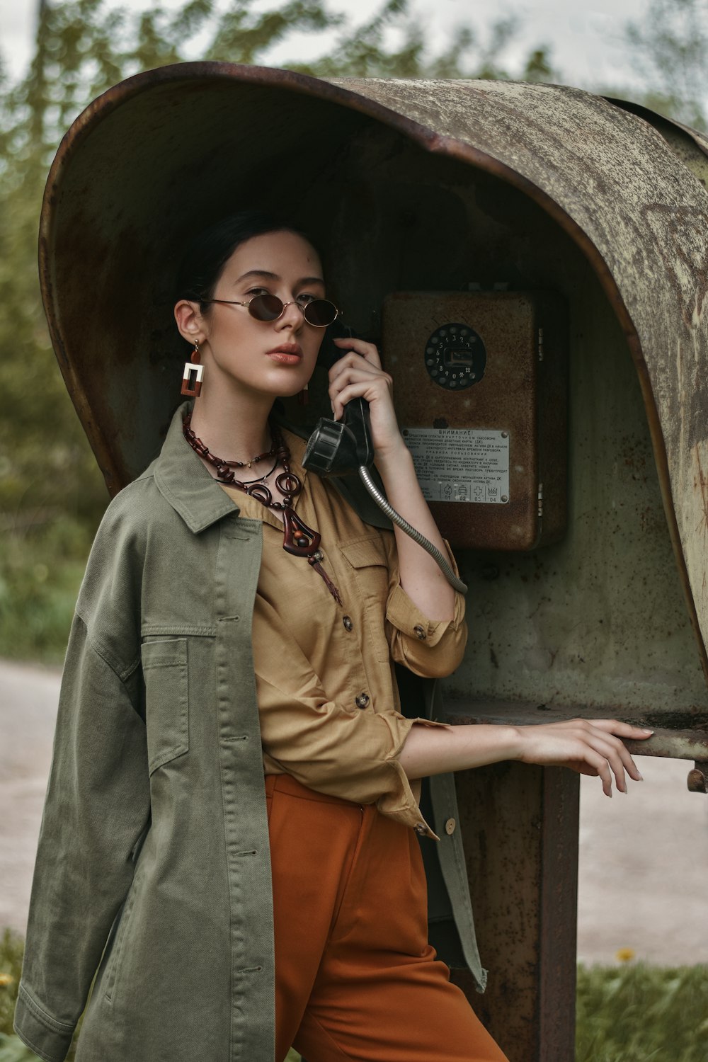 woman in brown coat wearing black sunglasses