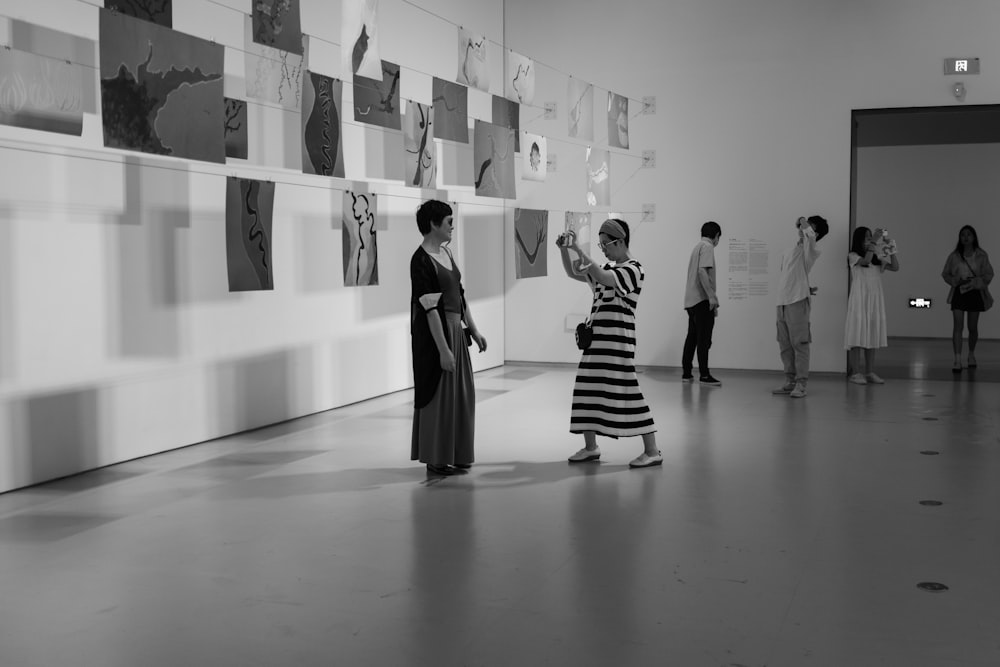 grayscale photo of people walking on hallway