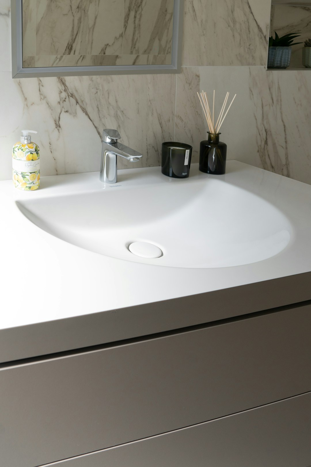 white ceramic sink with stainless steel faucet