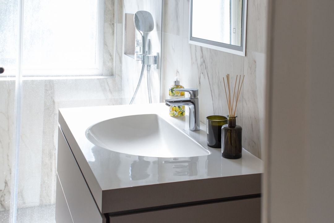 white ceramic sink with stainless steel faucet