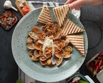 brown and white sliced food on white ceramic plate