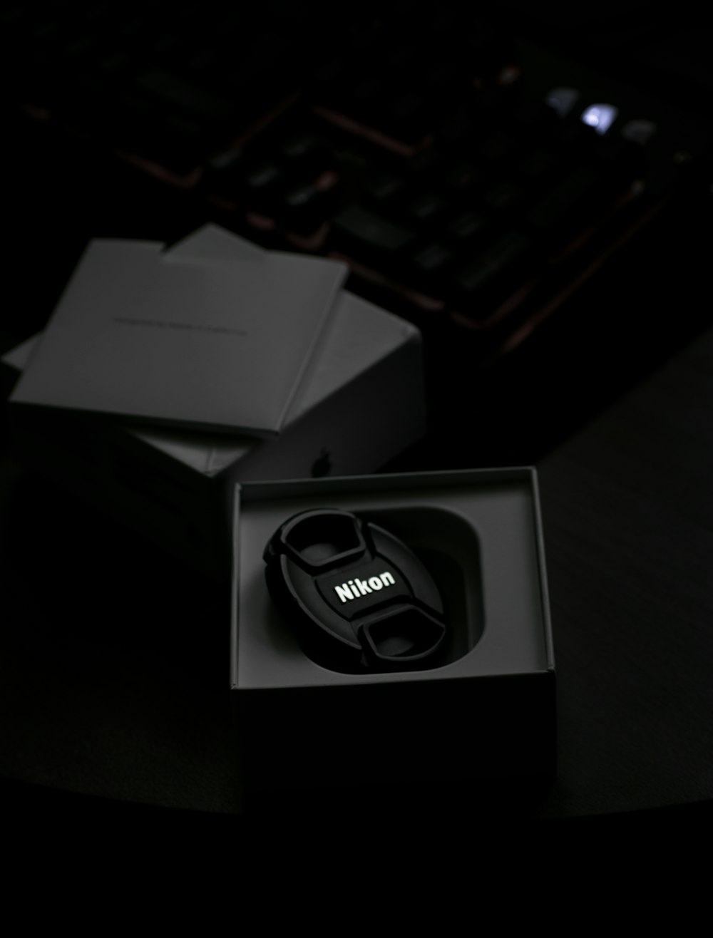 a black mouse and a black box on a desk