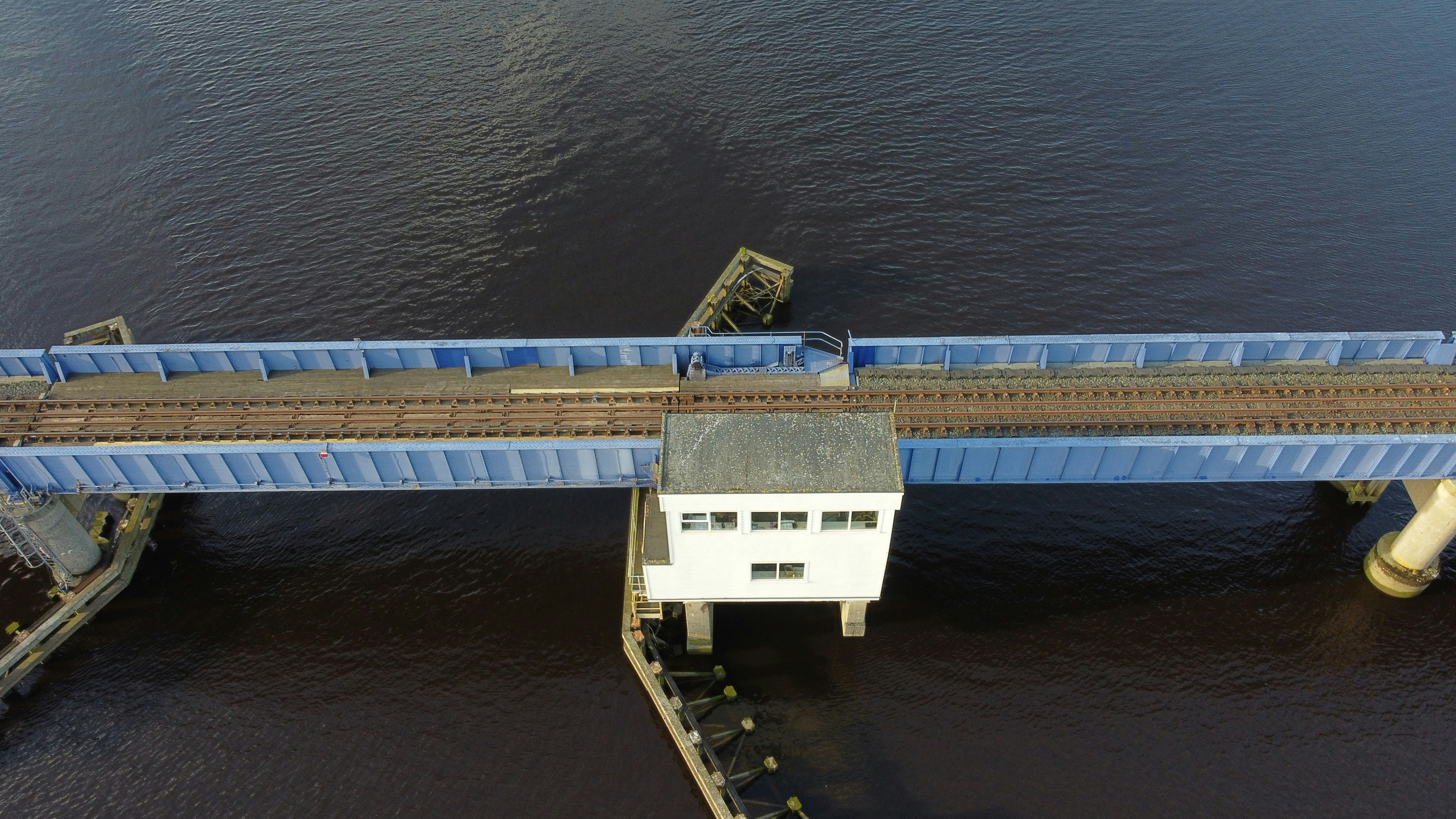 white and black concrete building on body of water during daytime