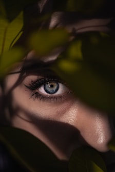 womans eyes with green leaves