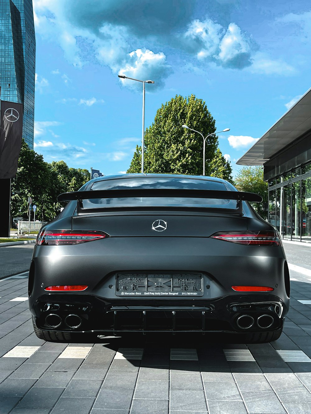 black porsche 911 parked on sidewalk during daytime