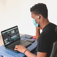 man in black crew neck t-shirt using black laptop computer