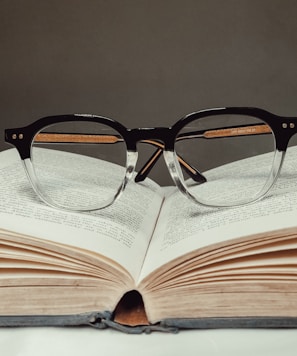 black framed eyeglasses on book page