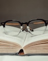 black framed eyeglasses on book page