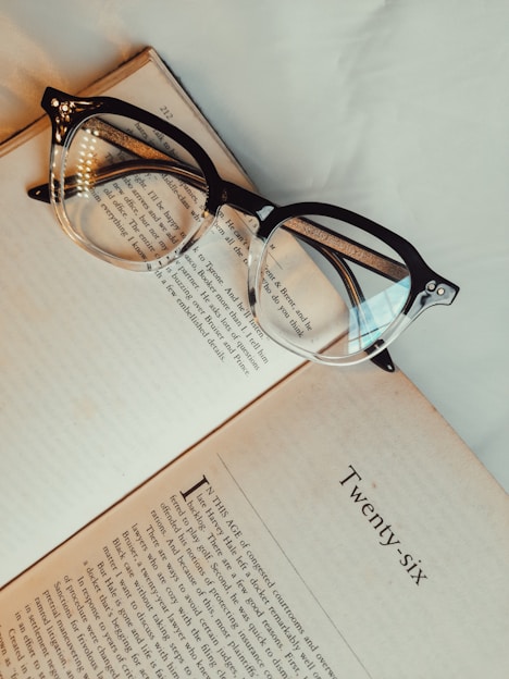 brown framed eyeglasses on white printer paper
