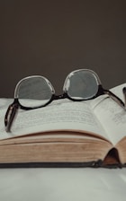 black framed eyeglasses on book page