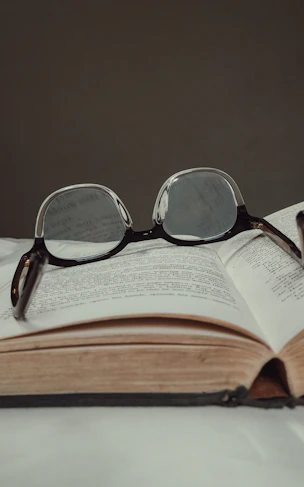black framed eyeglasses on book page