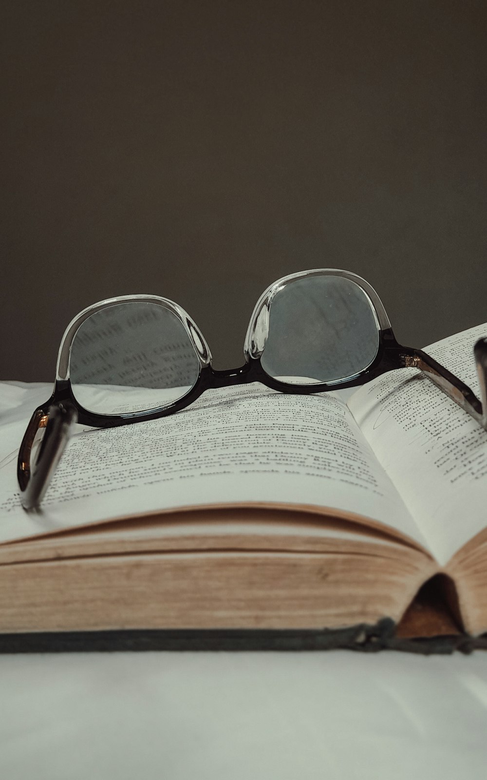 black framed eyeglasses on book page