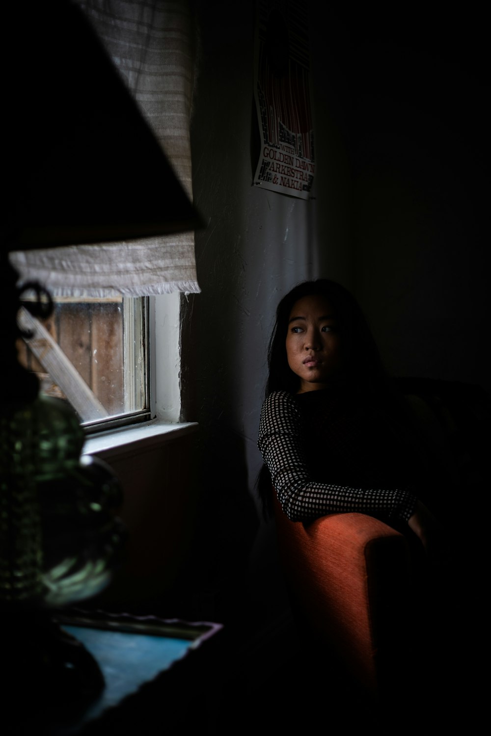 woman in black and white polka dot shirt sitting on chair