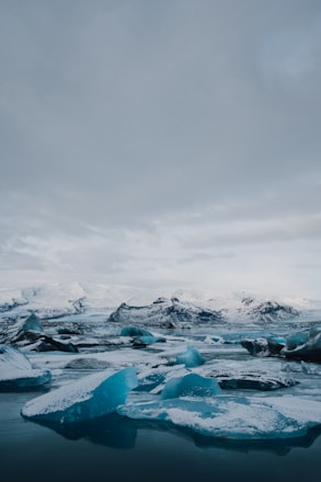 ice on body of water under cloudy sky