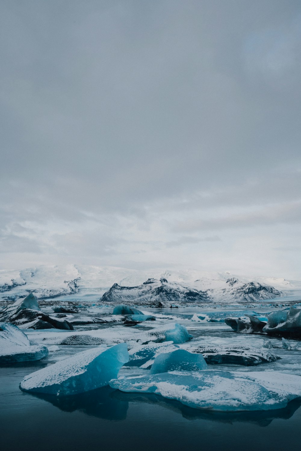 ice on body of water under cloudy sky