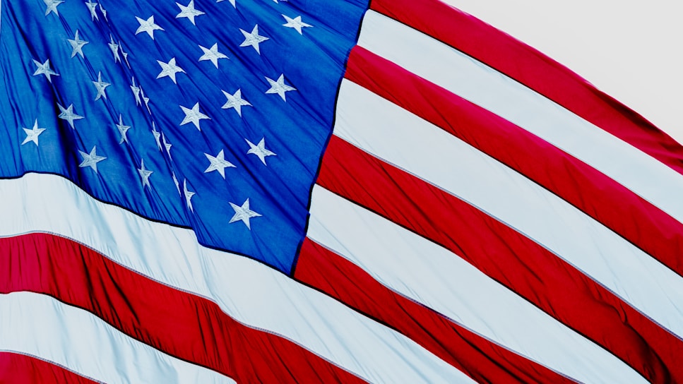 A close-up of a vintage American flag waving gently in the breeze.