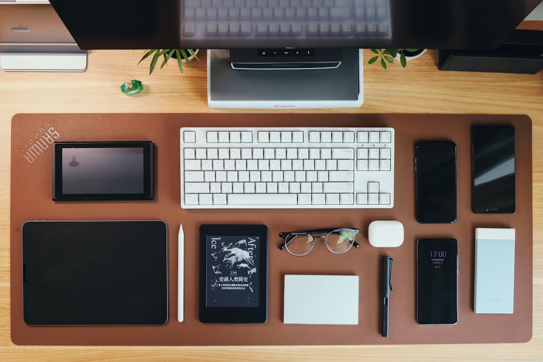 silver imac apple keyboard and magic mouse on brown wooden desk