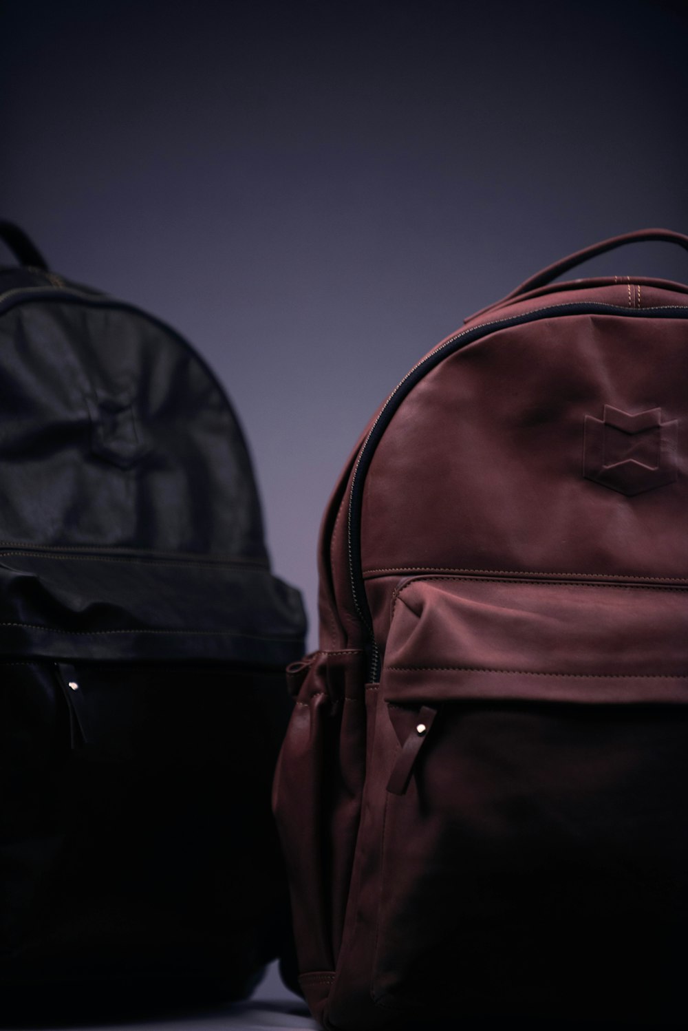 black and brown backpack on black surface