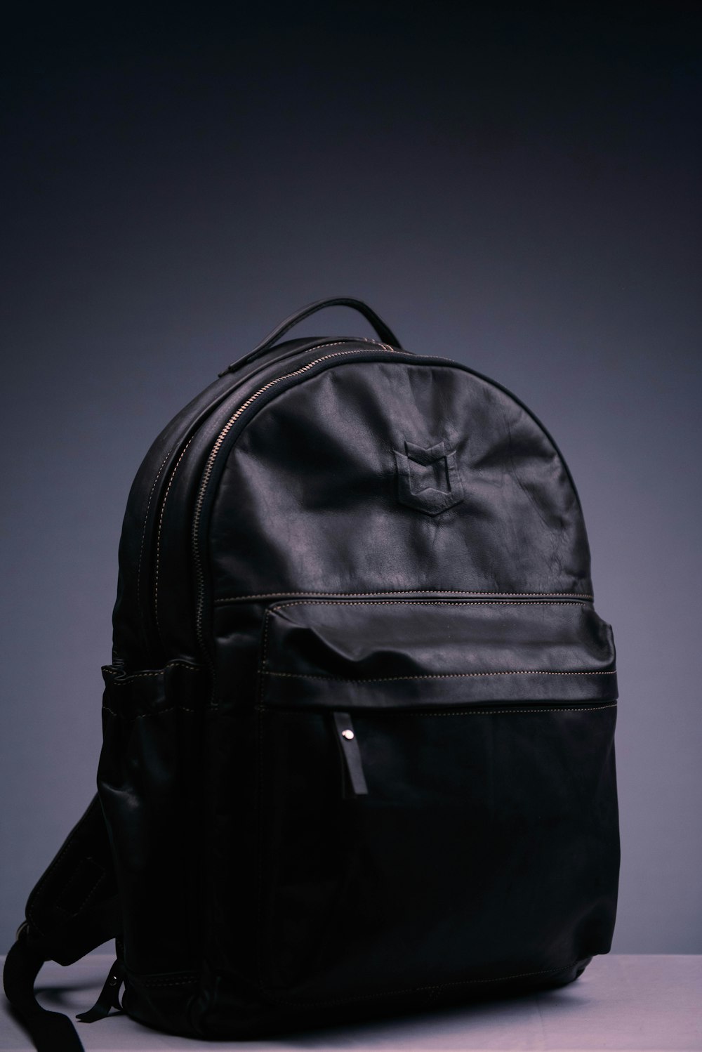 black nike backpack on purple surface