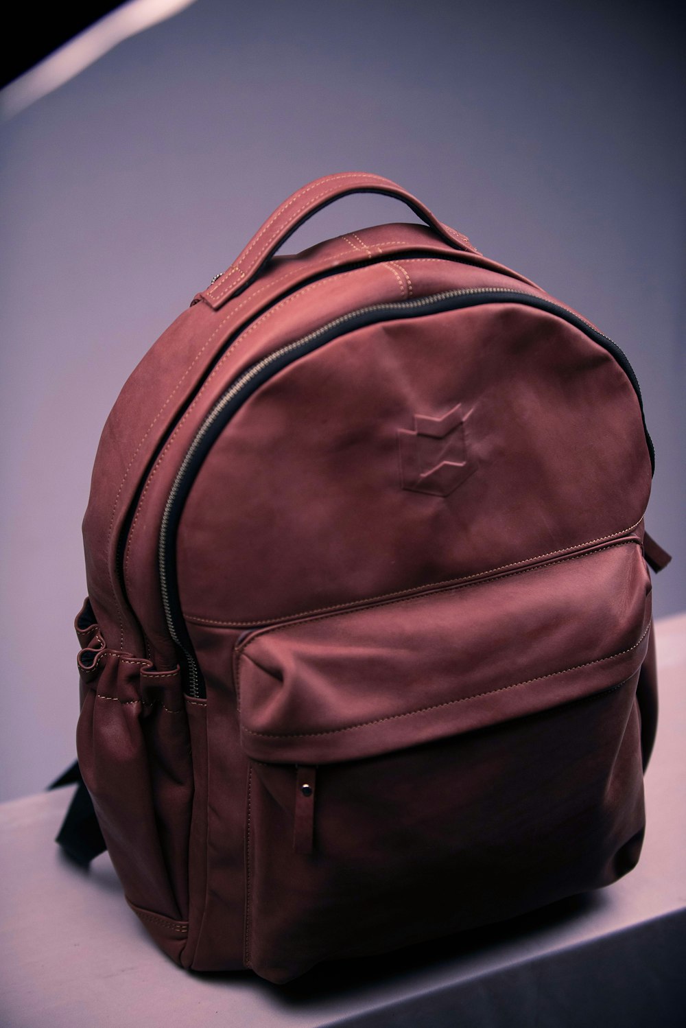 brown backpack on white textile