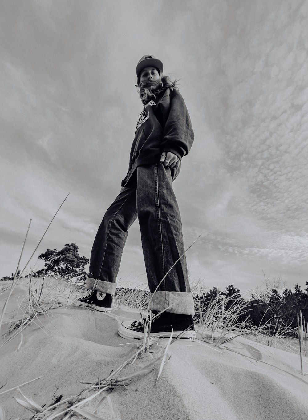 man in black jacket and pants standing on snow covered ground