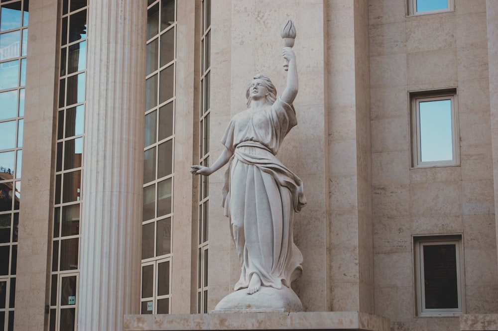 white concrete statue of a woman