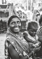 Nurse assisting a mother and child during a free surgical camp in a rural Indian village.