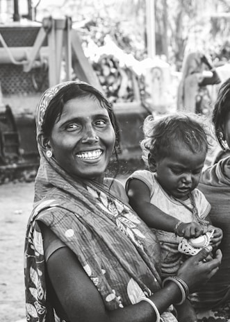 A woman happily holding her ration card after linking it successfully for the scheme.