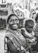 A smiling mother holding her young child outside a vibrant anganwadi center in rural Uttar Pradesh.