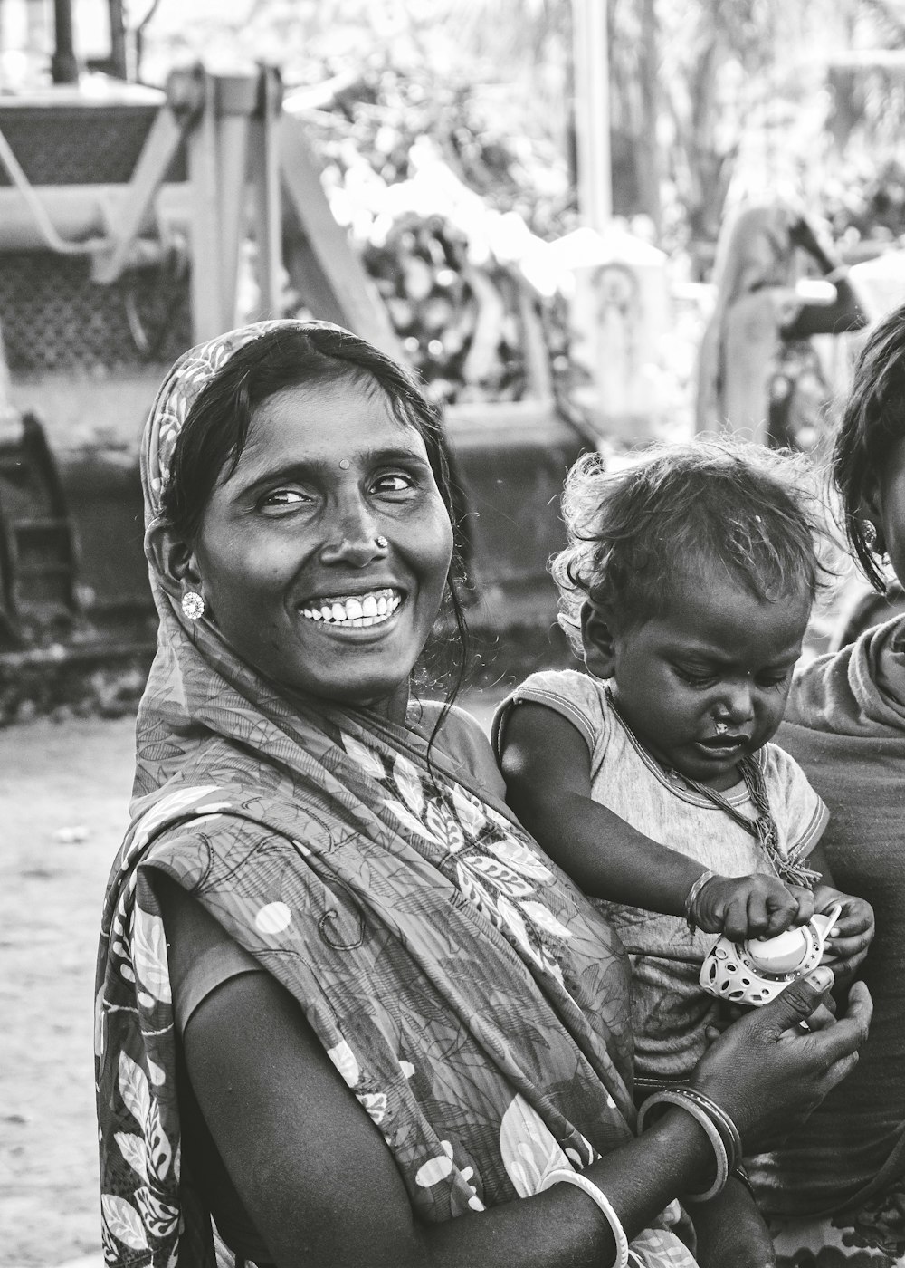 grayscale photo of woman carrying child