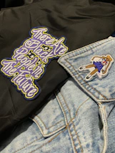 Close-up of embroidered motorcycle patch on denim jacket.