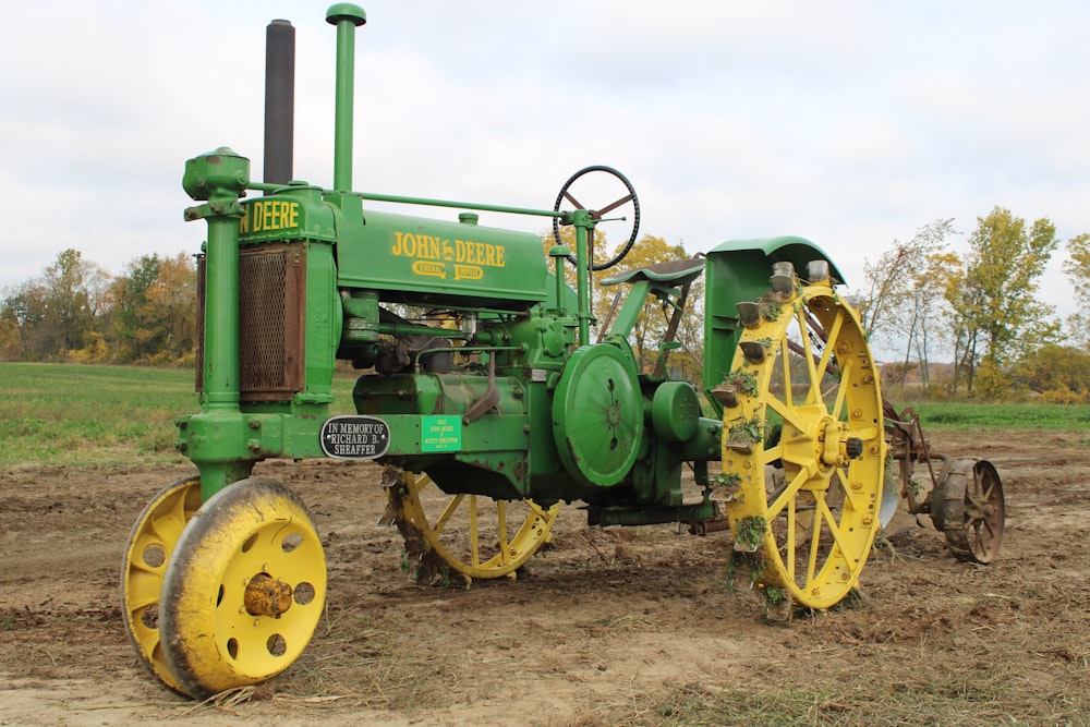 green and yellow tractor on brown field during daytime