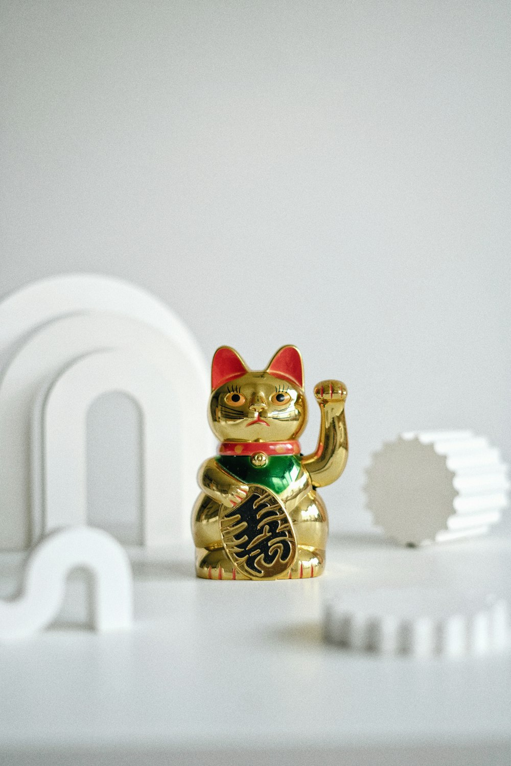 gold and red cat figurine