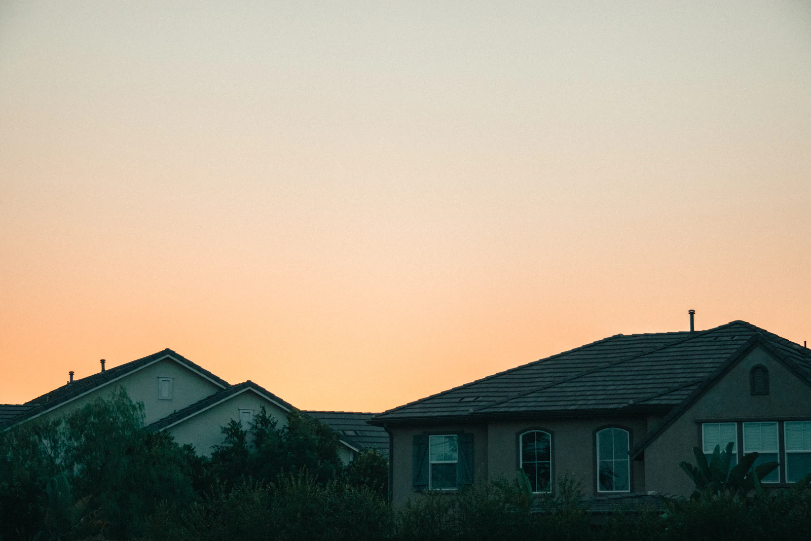 A tile-roofed house under an overcast sky.