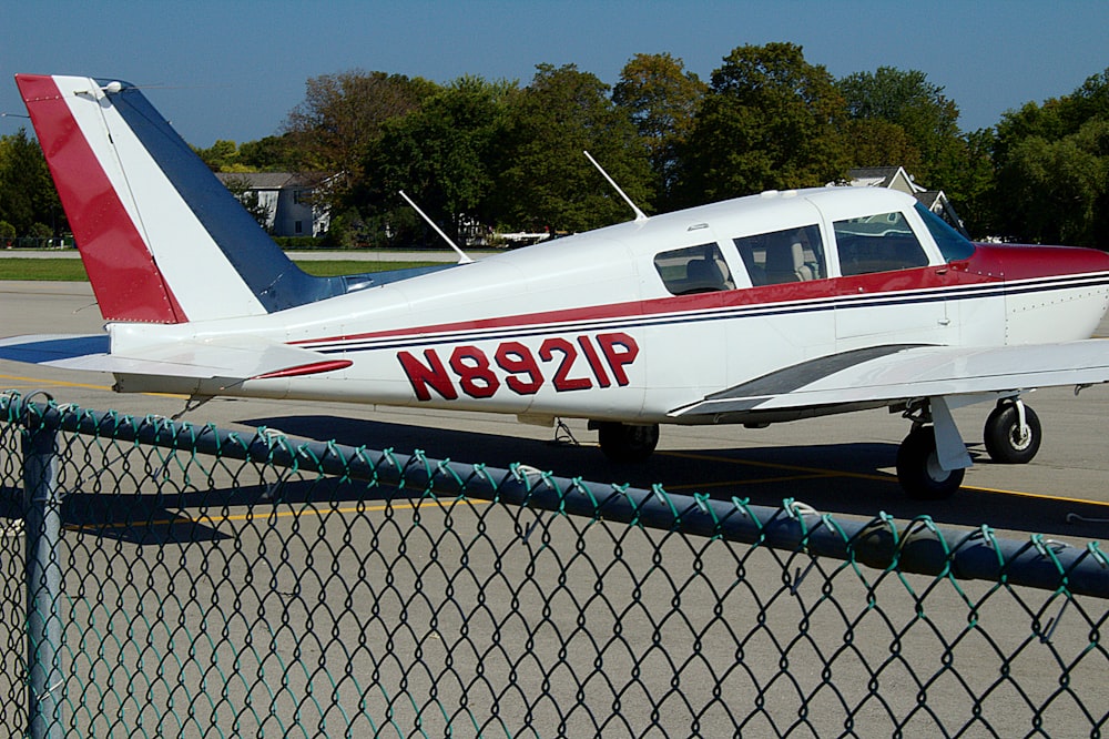 white and red airplane on a sunny day