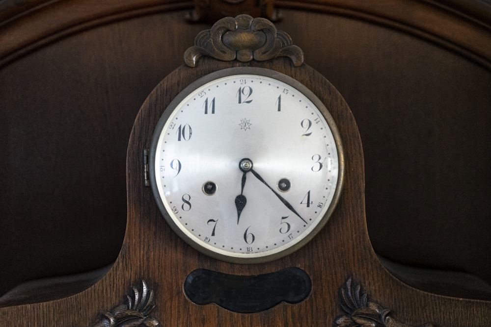 brown wooden framed analog wall clock