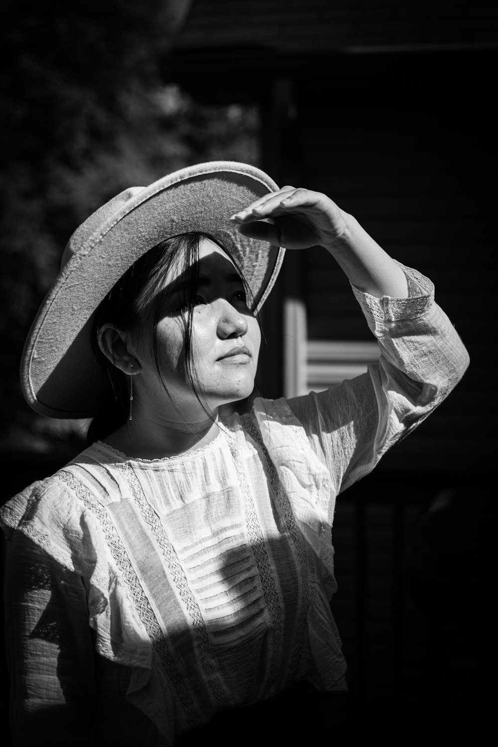 woman in white and black long sleeve shirt wearing brown hat