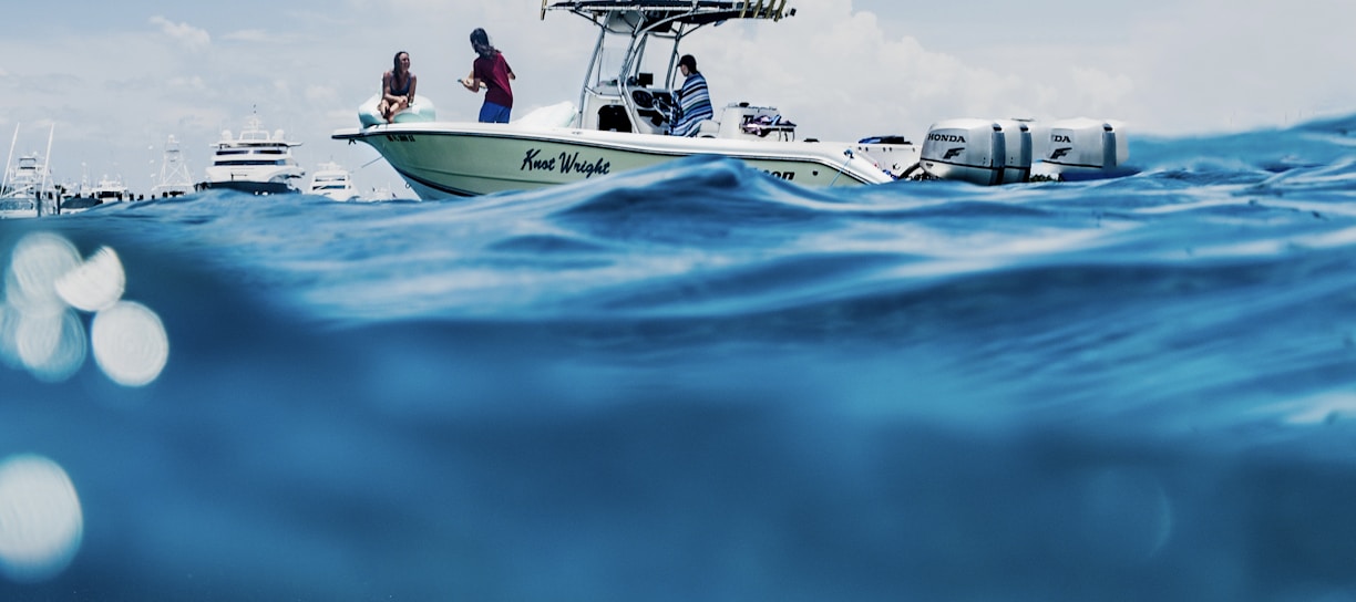 white and blue boat on sea during daytime