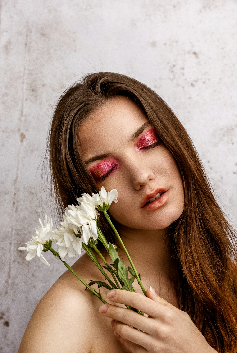 woman with white flower on her ear