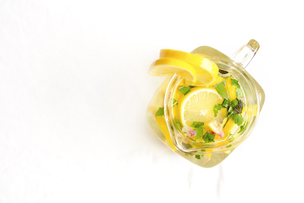 yellow and green fruit in clear glass container