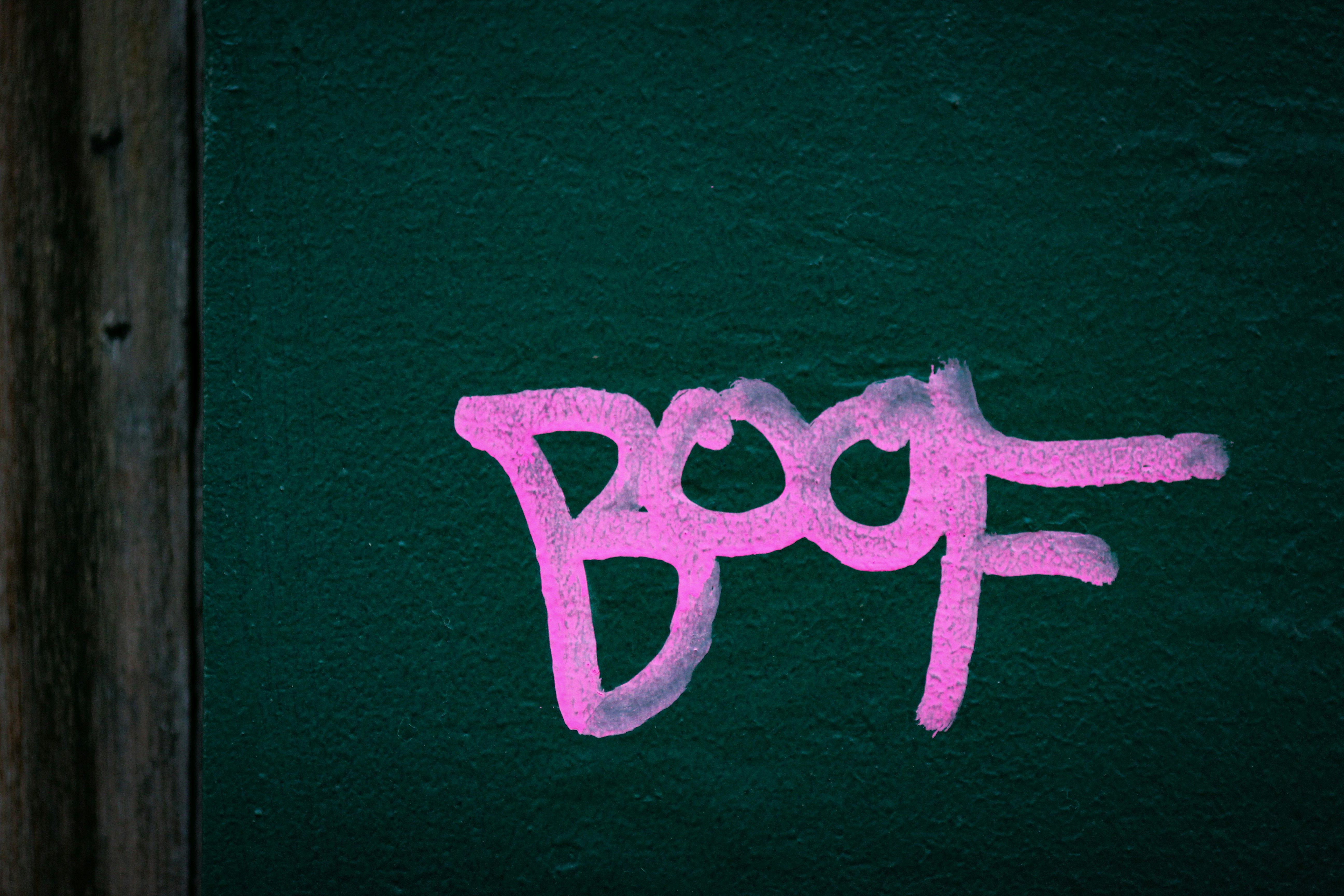 green letter b on pink wall