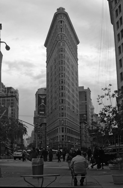 Robert Mendez photographing a bustling New York street scene with a minimalist backdrop.