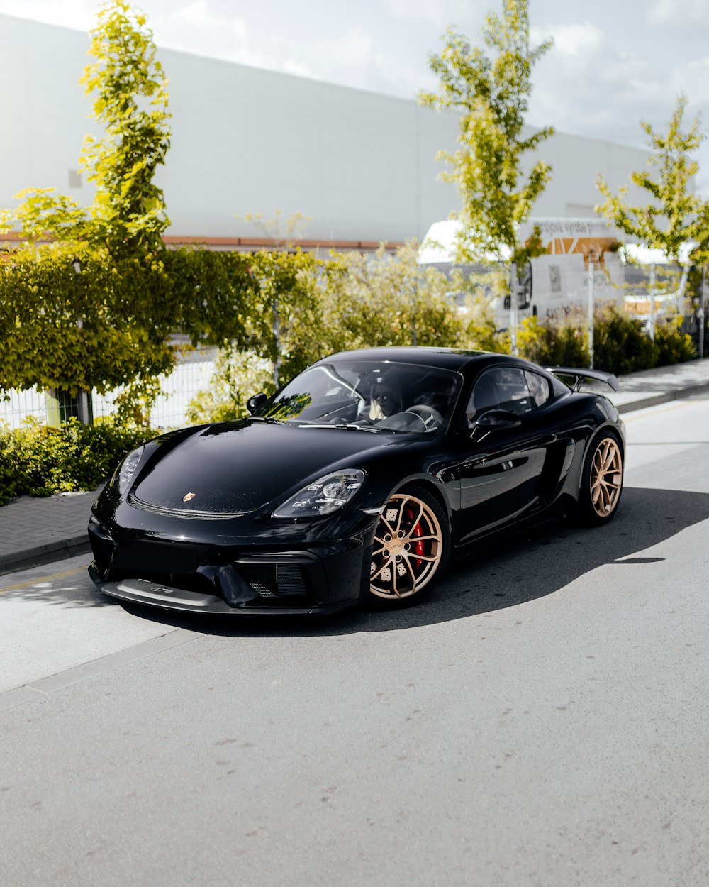 black porsche 911 parked on road during daytime