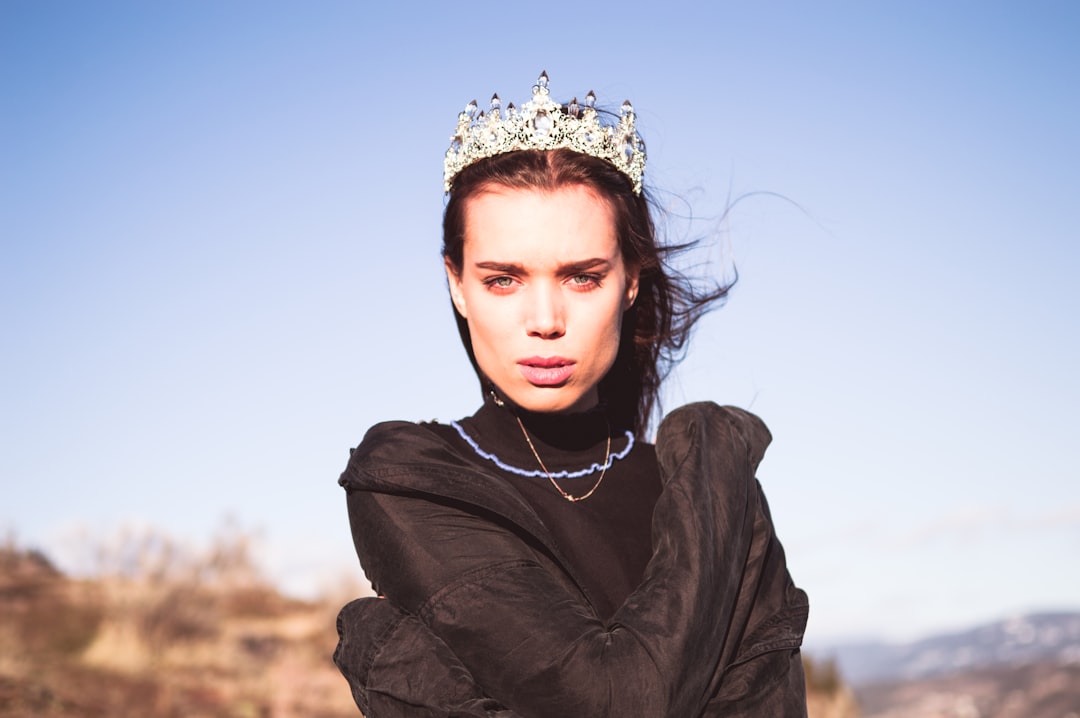 woman in black jacket wearing white flower crown